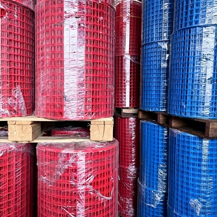 Palletized rolls of PVC-coated and galvanized welded wire mesh stored in the Hebei Flamingo warehouse