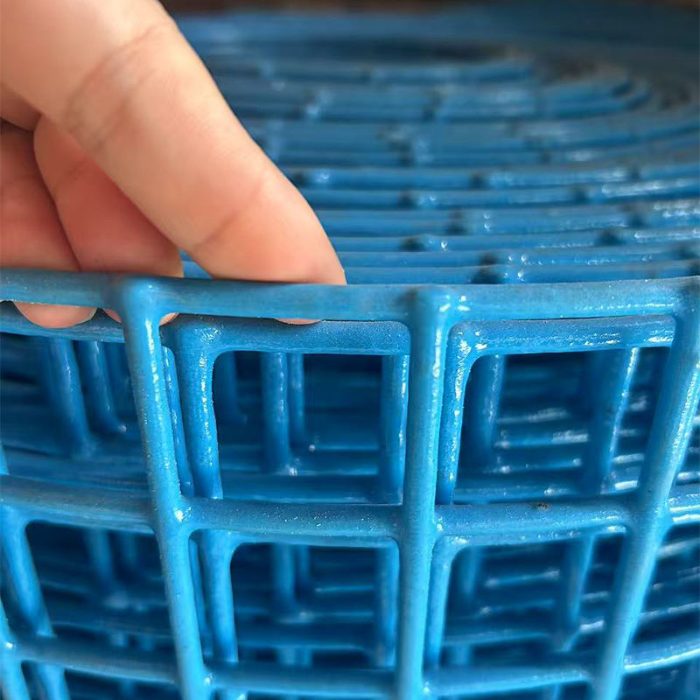 Close inspection of PVC-coated welded wire mesh during quality control at the Hebei Flamingo factory